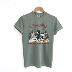 funny christmas shirt vintage cowboy raccoon tee with humorous design for holiday celebrations and unique style isqid