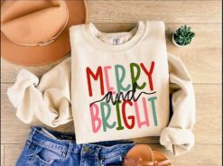 Funny Christmas Shirt Merry and Bright Sweatshirt with Believe Design for Holiday Celebrations and Festive Gatherings