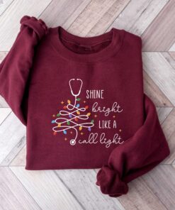 vintage christmas nurse sweatshirt shine bright like a call light merry nurse shirt with tree design for holiday cheer gms9e scaled