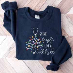 vintage christmas nurse sweatshirt shine bright like a call light merry nurse shirt with tree design for holiday cheer rlk4a scaled