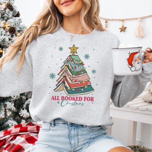 vintage christmas sweatshirt for book lovers featuring a book tree design ideal for holiday gatherings and teacher appreciation azroy scaled