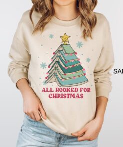 vintage christmas sweatshirt for book lovers featuring books and christmas tree design perfect for holiday gatherings pakkc