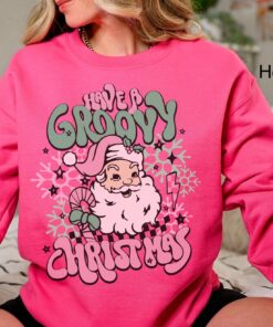 vintage christmas sweatshirt for women featuring retro santa design in pink for a groovy holiday look 06rdl