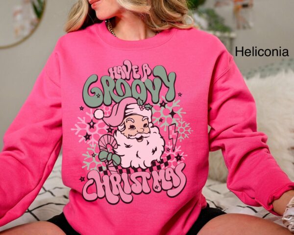 vintage christmas sweatshirt for women featuring retro santa design in pink for a groovy holiday look 06rdl