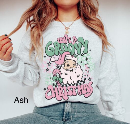 vintage christmas sweatshirt for women featuring retro santa design in pink for a groovy holiday look ihfwu