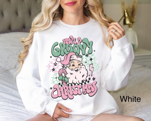 vintage christmas sweatshirt for women featuring retro santa design in pink for a groovy holiday look