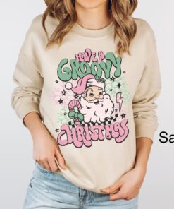 vintage christmas sweatshirt for women featuring retro santa design in pink for a groovy holiday look ov26r