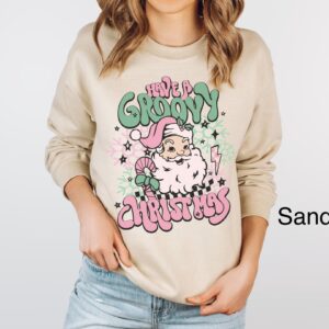 vintage christmas sweatshirt for women featuring retro santa design in pink for a groovy holiday look ov26r