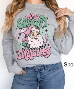 vintage christmas sweatshirt for women featuring retro santa design in pink for a groovy holiday look p1vpp