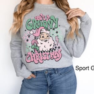 vintage christmas sweatshirt for women featuring retro santa design in pink for a groovy holiday look p1vpp