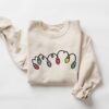 vintage christmas sweatshirt for women with retro design and festive lights print lcodq