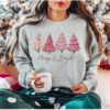 vintage christmas sweatshirt with pink christmas tree design and merry bright print for festive holiday style ro9qq