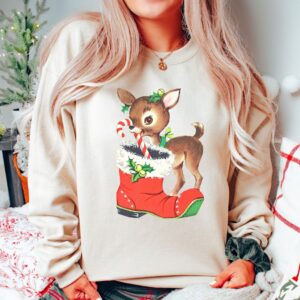 vintage christmas sweatshirt with retro reindeer design in pink cute baby deer shirt for holiday celebrations and festive gatherings dt2n9