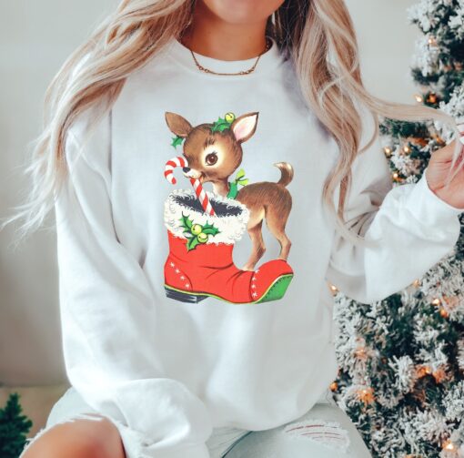 vintage christmas sweatshirt with retro reindeer design in pink cute baby deer shirt for holiday celebrations and festive gatherings nrebm