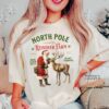 vintage christmas t shirt featuring retro santa and reindeer design for a fun holiday look at the north pole vdegd