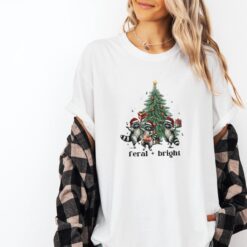 Vintage Christmas T Shirt Feral Raccoon Design Funny Holiday Tee with Christmas Tree Graphic Ideal for Winter Celebrations