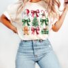 vintage christmas t shirt with aesthetic bow design and christmas tree cake graphic in comfort colors for a girly look kyn2r