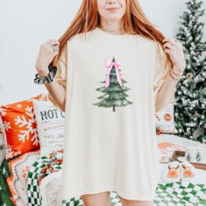 vintage christmas t shirt with pink bow design and christmas tree graphic for a fun holiday look d1chi