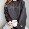 custom grandma sweatshirt with grandchildren names on sleeve personalized mothers day gift new grandma announcement heart print sfodh scaled