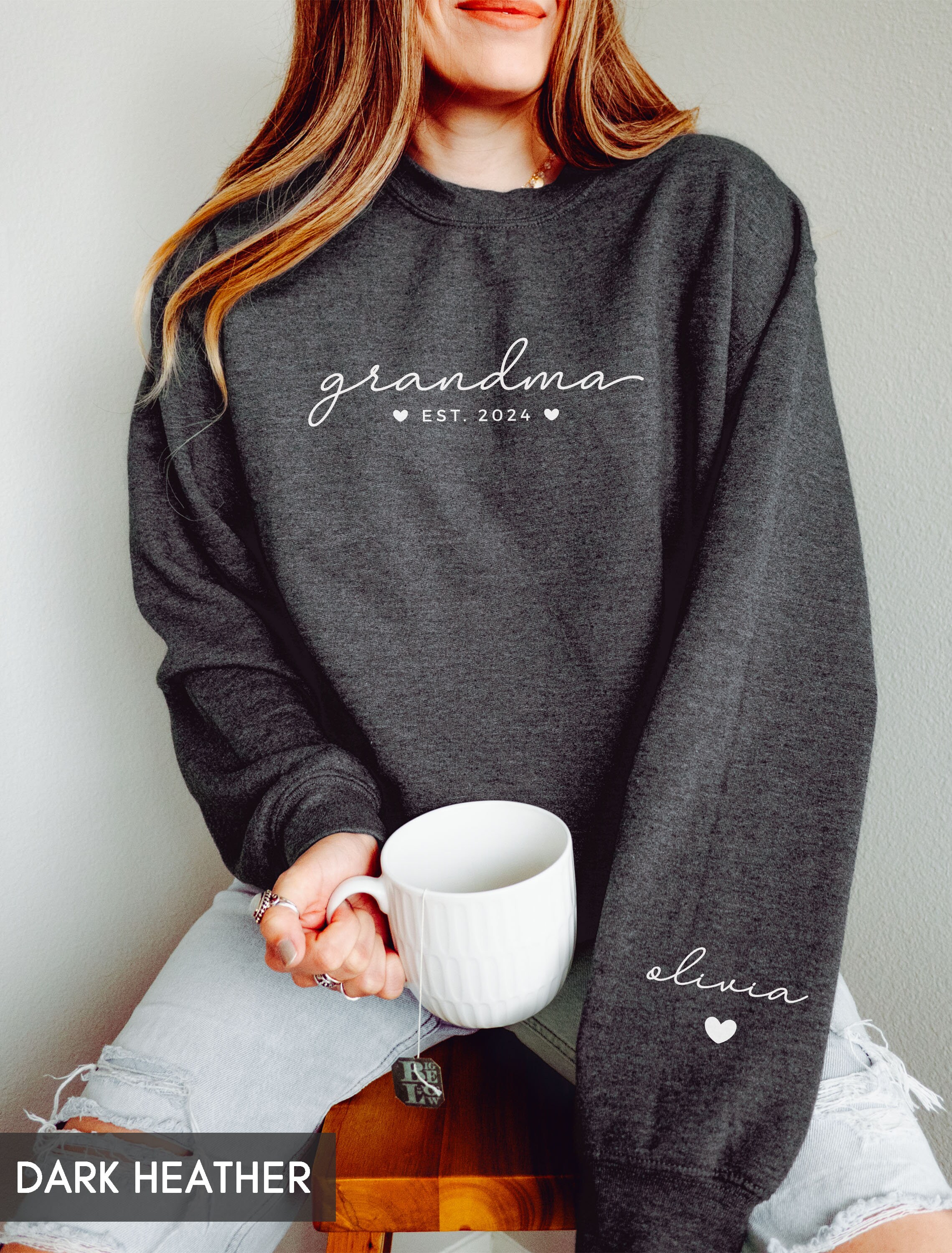 custom grandma sweatshirt with grandchildren names on sleeve personalized mothers day gift new grandma announcement heart print sfodh scaled