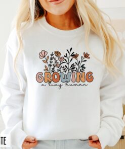 funny pregnancy announcement sweatshirt for new moms growing a human with groovy floral design and baby reveal hoodie sldcp