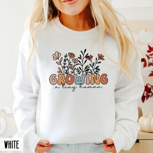 funny pregnancy announcement sweatshirt for new moms growing a human with groovy floral design and baby reveal hoodie sldcp