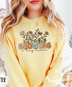 funny pregnancy sweatshirt growing a tiny human groovy wildflowers baby announcement cute new mom shirt ft1ti