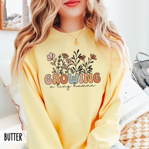 funny pregnancy sweatshirt growing a tiny human groovy wildflowers baby announcement cute new mom shirt ft1ti