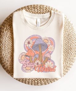 stay weird retro t shirt with boho mushroom design and floral print for unique hippie style gqa6m