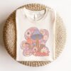stay weird retro t shirt with boho mushroom design and floral print for unique hippie style gqa6m scaled